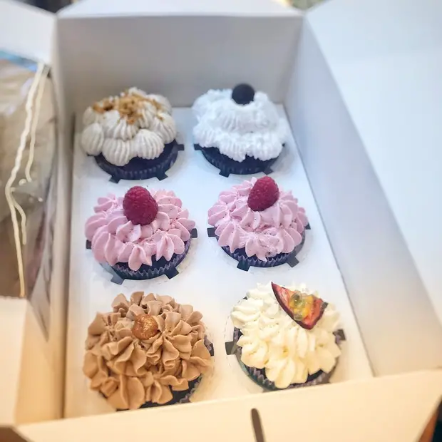 Box of various cupcakes