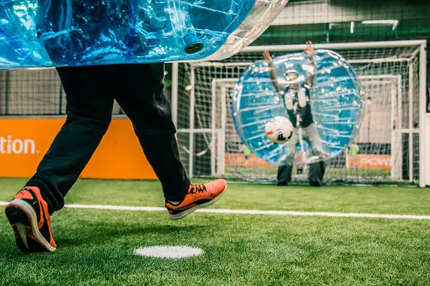 Two people playing bubble-football