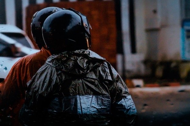 Riding a scooter in rainy day