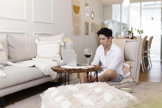 man with glass of wine in hotel